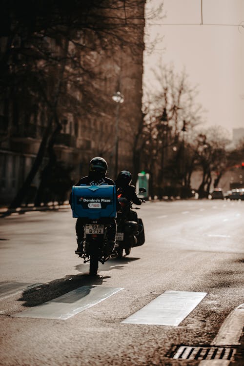 Free Person Riding A Motorcycle To Deliver Food Stock Photo