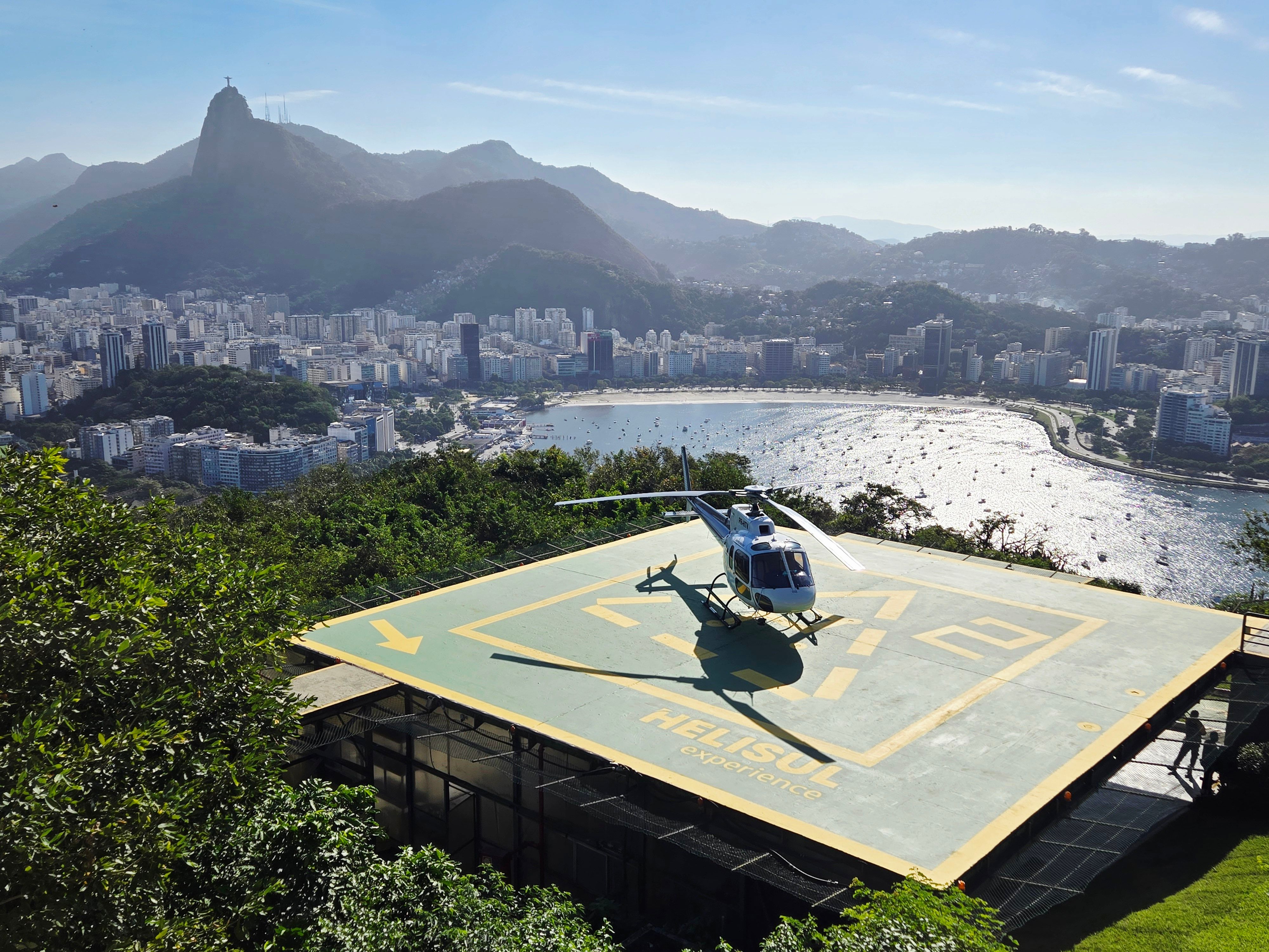 Helicopter lands on a helipad with panoramic views of Rio de Janeiro and Sugarloaf Mountain.