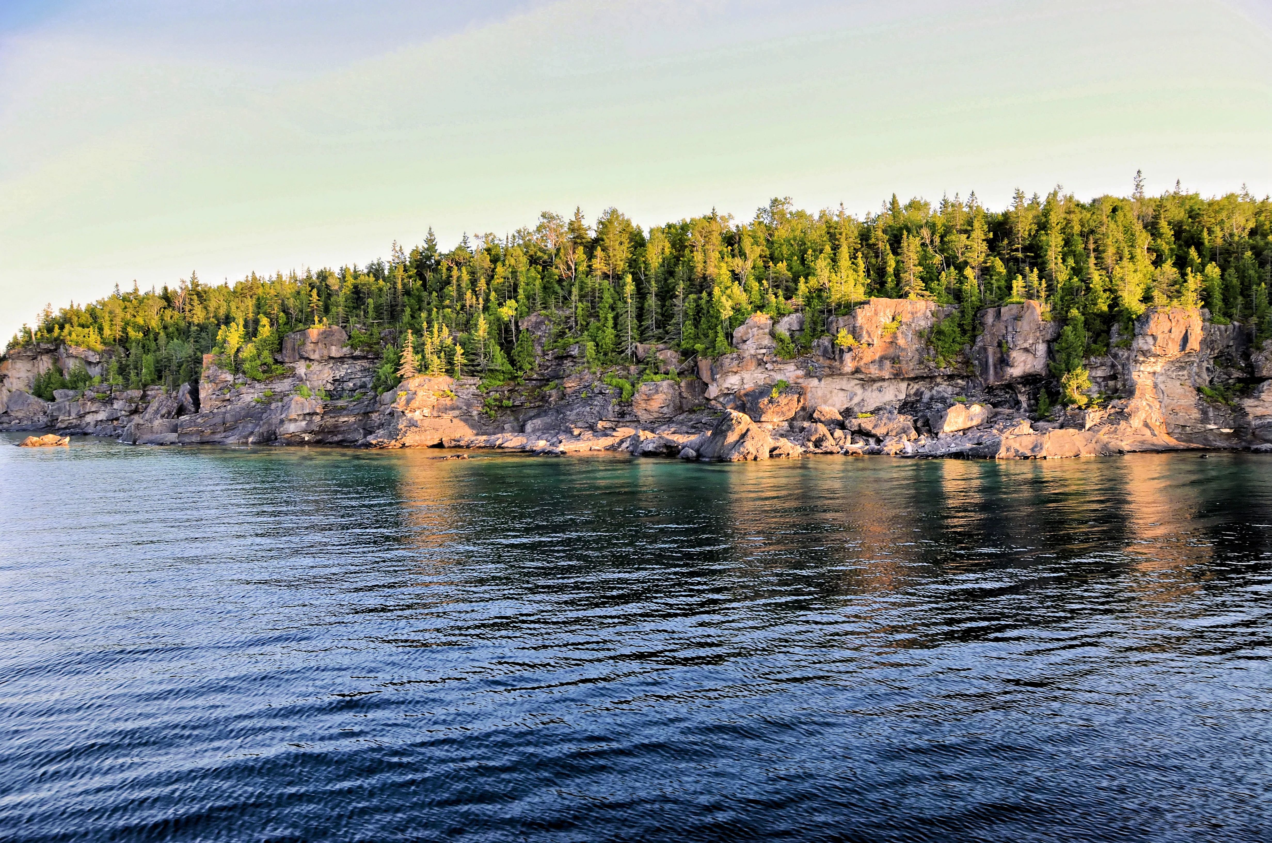 Cliffs and forested area along the Northern Bruce Peninsula, Ontario captured in tranquil daylight.