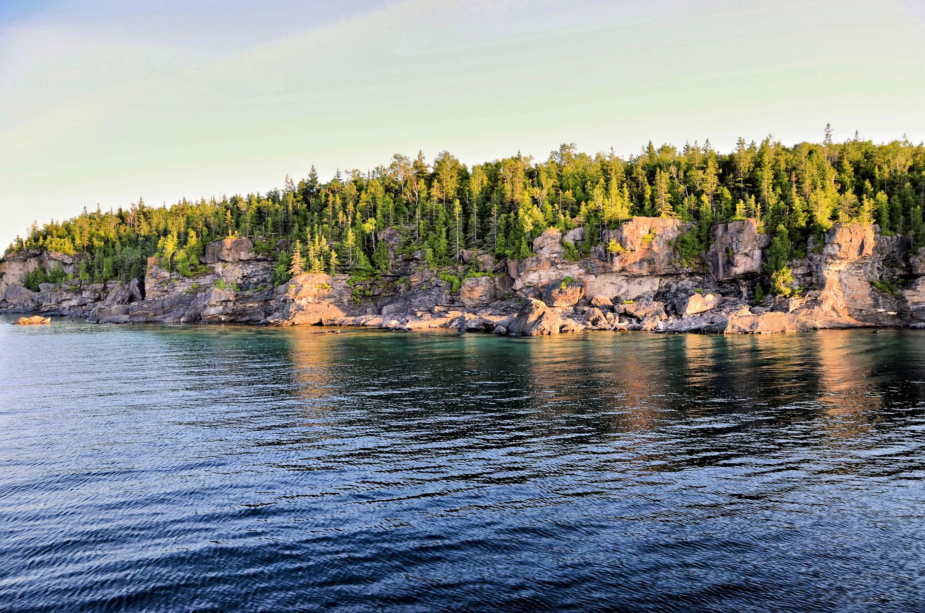Cliffs and forested area along the Northern Bruce Peninsula, Ontario captured in tranquil daylight.