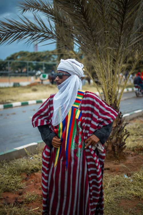 Free Man in traditional Hausa attire outdoors in Nigeria. Stock Photo