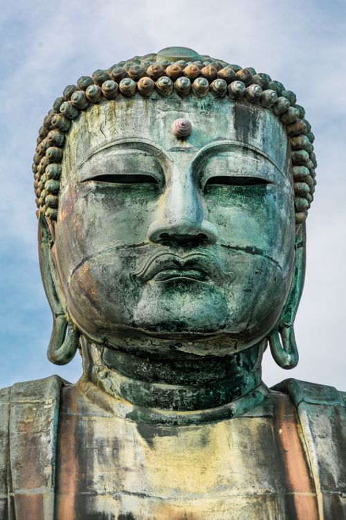 Free Close-up of the Great Buddha statue in Kamakura, an iconic bronze monument symbolizing peace and enlightenment. Stock Photo