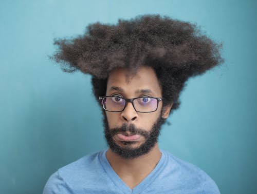 Man in Blue Crew Neck Shirt Wearing Black Framed Eyeglasses