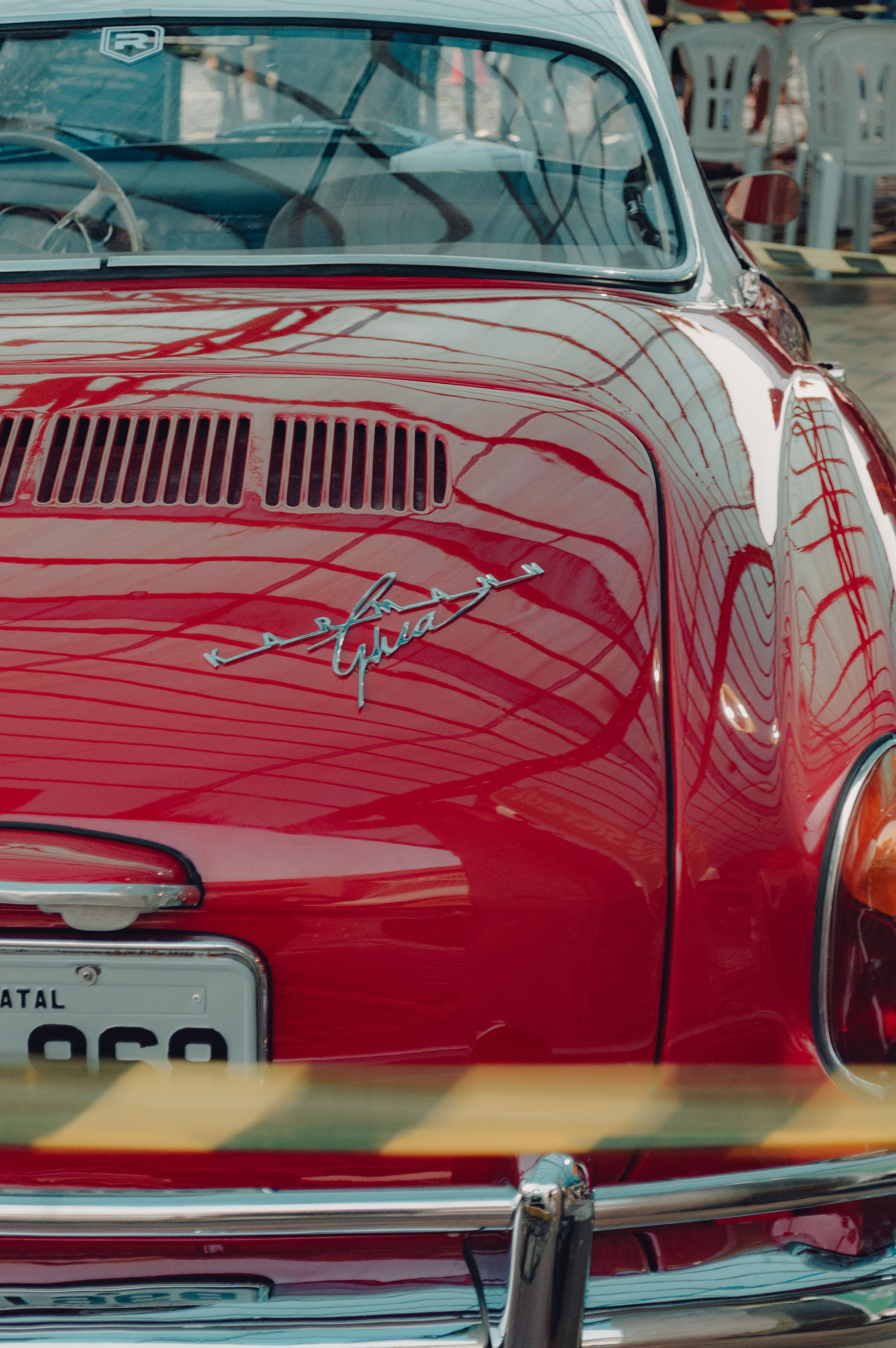 Rear view of a vintage red car with reflections in Natal, Brazil. Classic elegance captured.