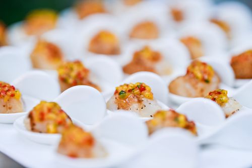 Free Delicious seafood appetizer served elegantly on white spoons, garnished with colorful toppings. Stock Photo