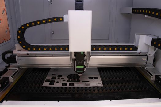 Photo of a high-tech industrial laser cutting machine used for precision manufacturing.