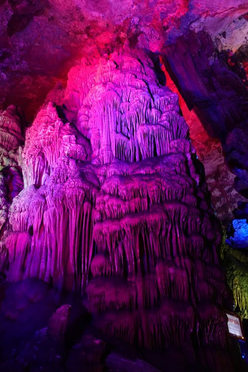 Free Colorful stalactite formation captured in a stunningly lit cave setting. Stock Photo