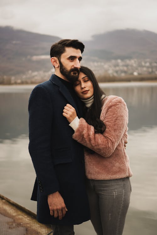 Free Woman Leaning On Man Wearing A Coat Stock Photo