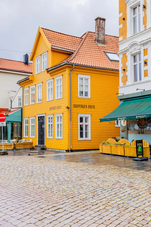 Free Bright yellow wooden house in historic Bergen, Norway, showcasing Scandinavian architecture. Stock Photo