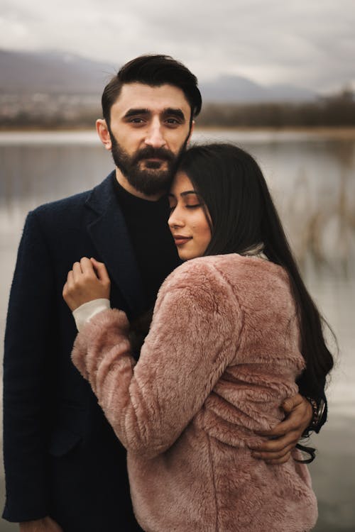 Free Woman Leaning On Man Wearing A Coat Stock Photo