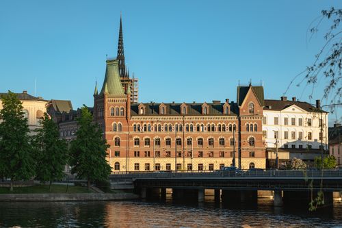 Free Beautiful historic building by the water in Stockholm, Sweden, showcasing classic European architecture at sunset. Stock Photo