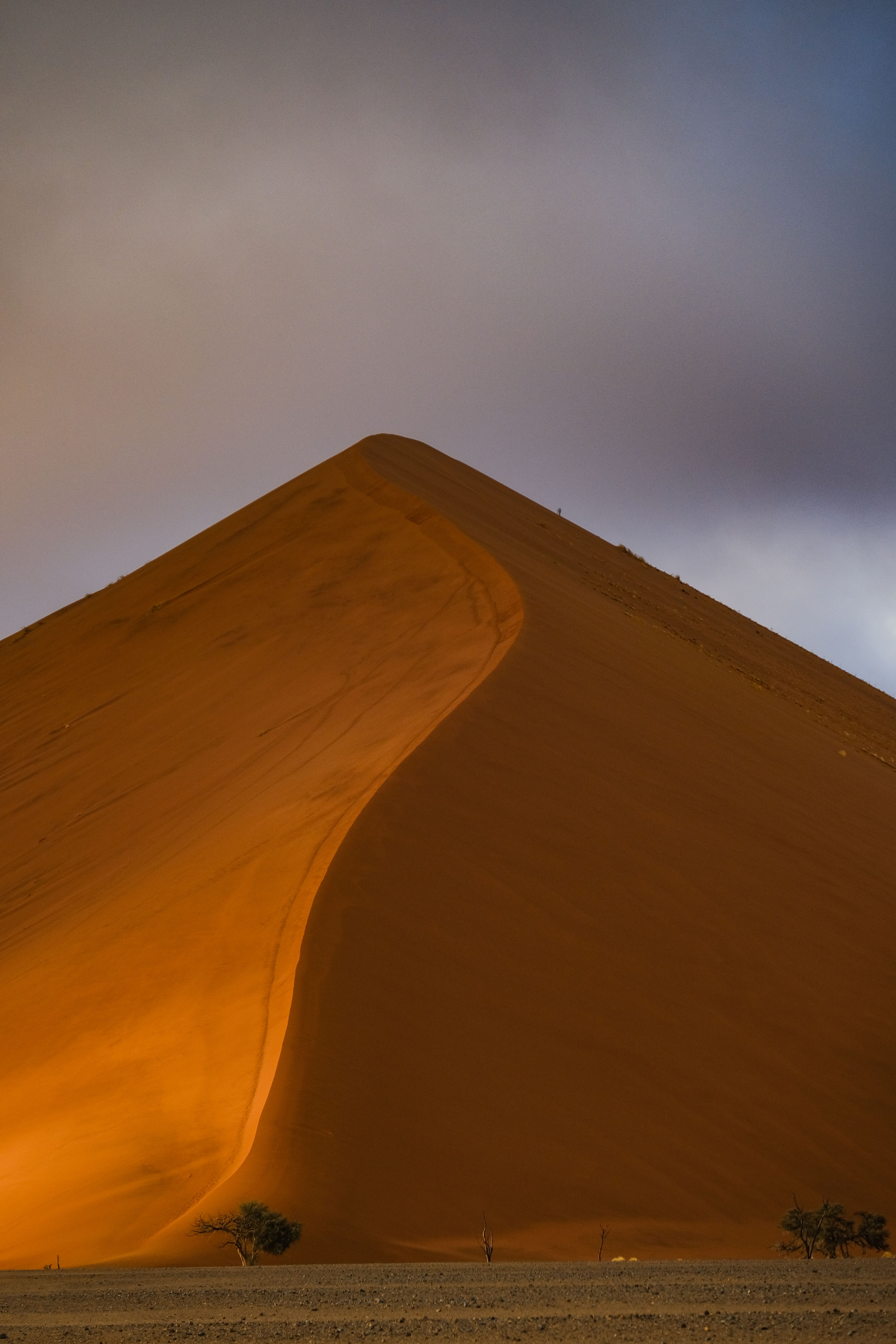 Captured at sunrise, this breathtaking dune in the Namib Desert highlights the natural beauty and vibrant colors of Namibia.