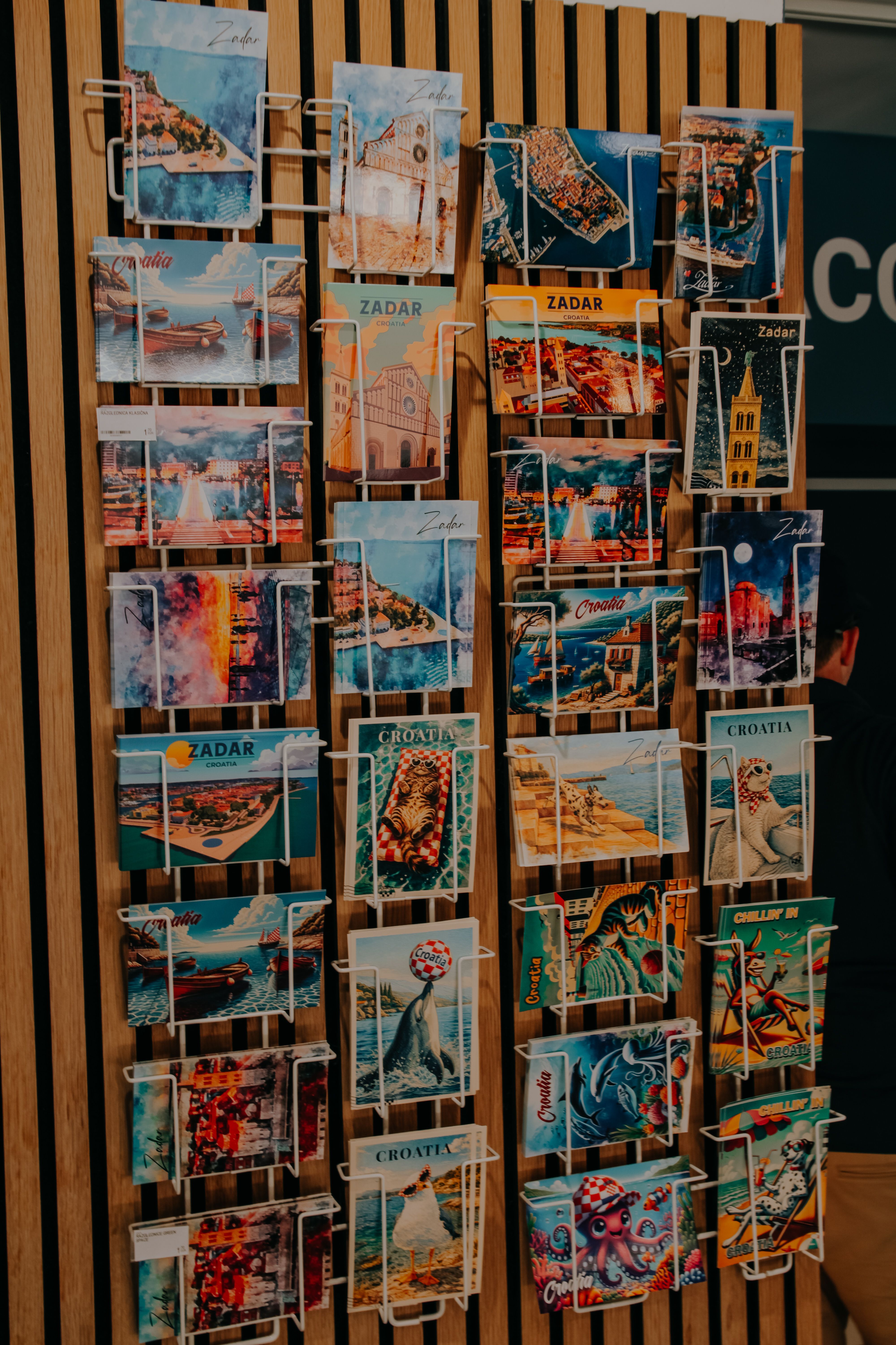 A vibrant selection of Zadar postcards on display, featuring iconic landmarks and scenic views of Croatia.