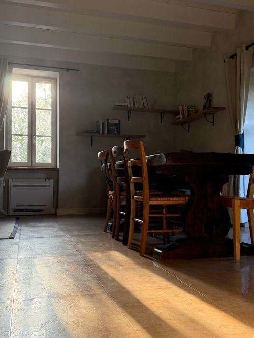 Free Cozy sunlit dining room with wooden furniture and shelves in a rustic French interior in Lusignan-Petit. Stock Photo