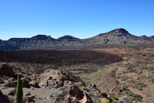 Free Explore the stunning volcanic terrain of Teide National Park under a clear blue sky. Stock Photo
