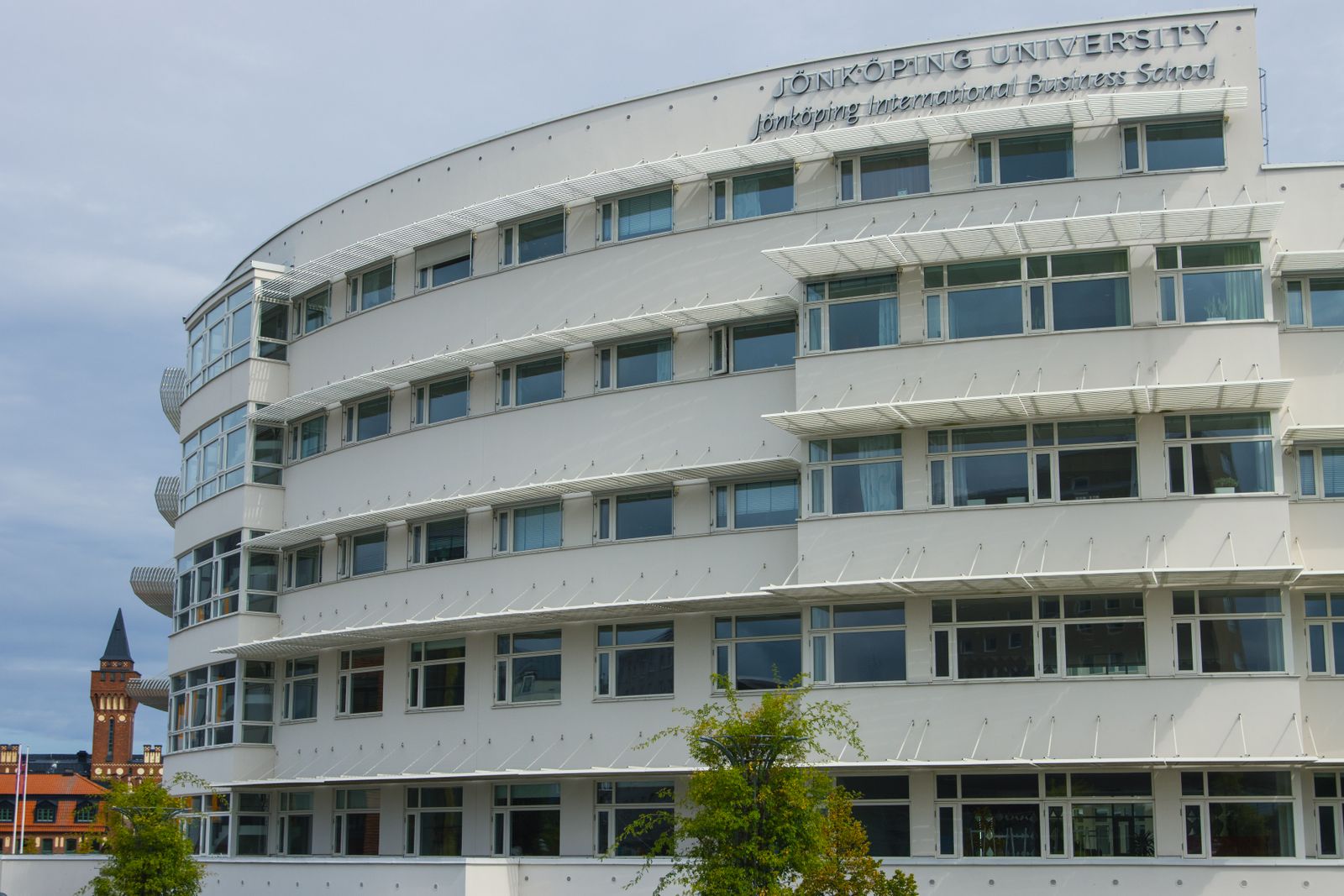 The curved facade of a modern institutional building