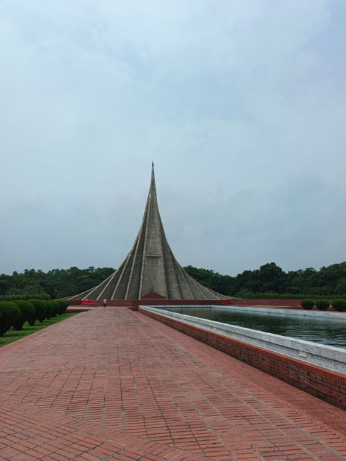 Free View of the iconic National Martyrs' Memorial against a cloudy sky in Dhaka, Bangladesh. Stock Photo