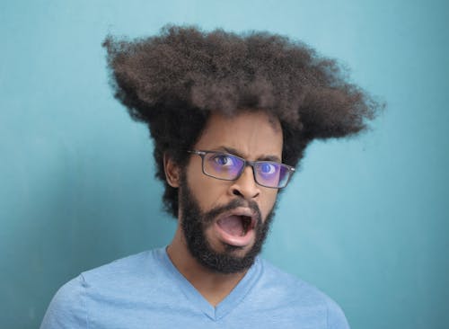 Man in Blue V Neck Shirt Wearing Black Framed Eyeglasses