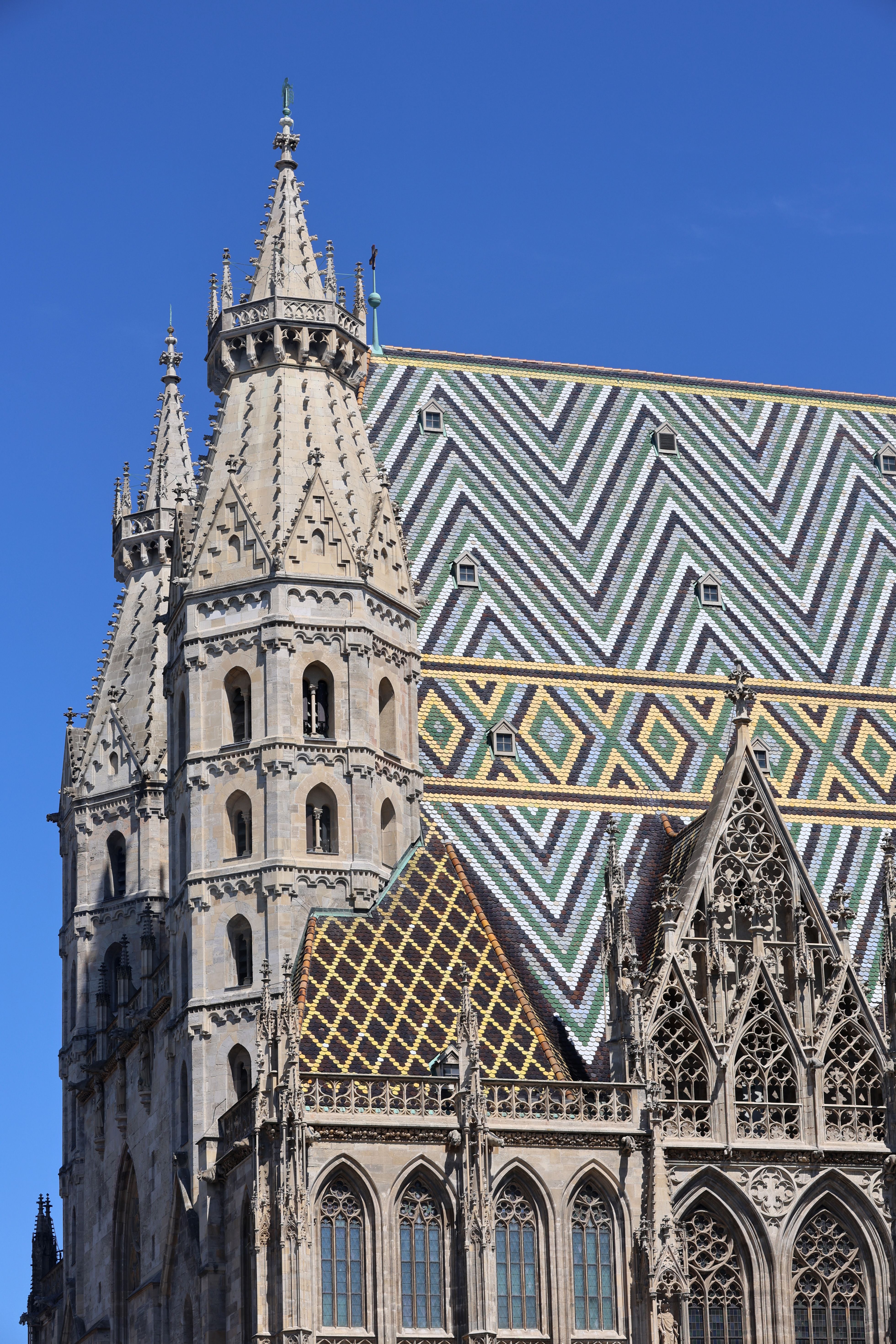 The intricate tiled roof of St. Stephen's Cathedral in sunny Vienna, Austria.