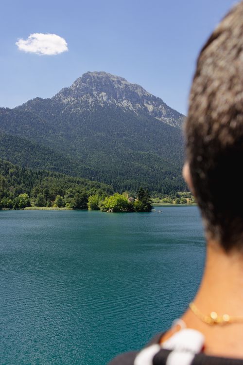 Free A serene mountain and lake landscape with a person in the foreground, captured in Greece. Stock Photo