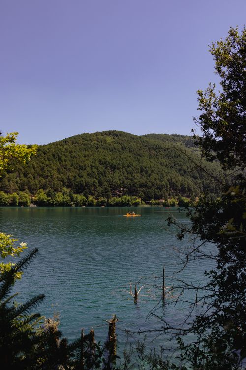 Free A tranquil lake with lush greenery and hills in Greece, perfect for nature and travel enthusiasts. Stock Photo