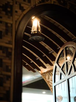 A vintage lantern reflecting in an ornate arched mirror indoors in Dubai.