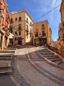 Quaint cobblestone street with colorful buildings in Tarragona, Spain's historic old town.