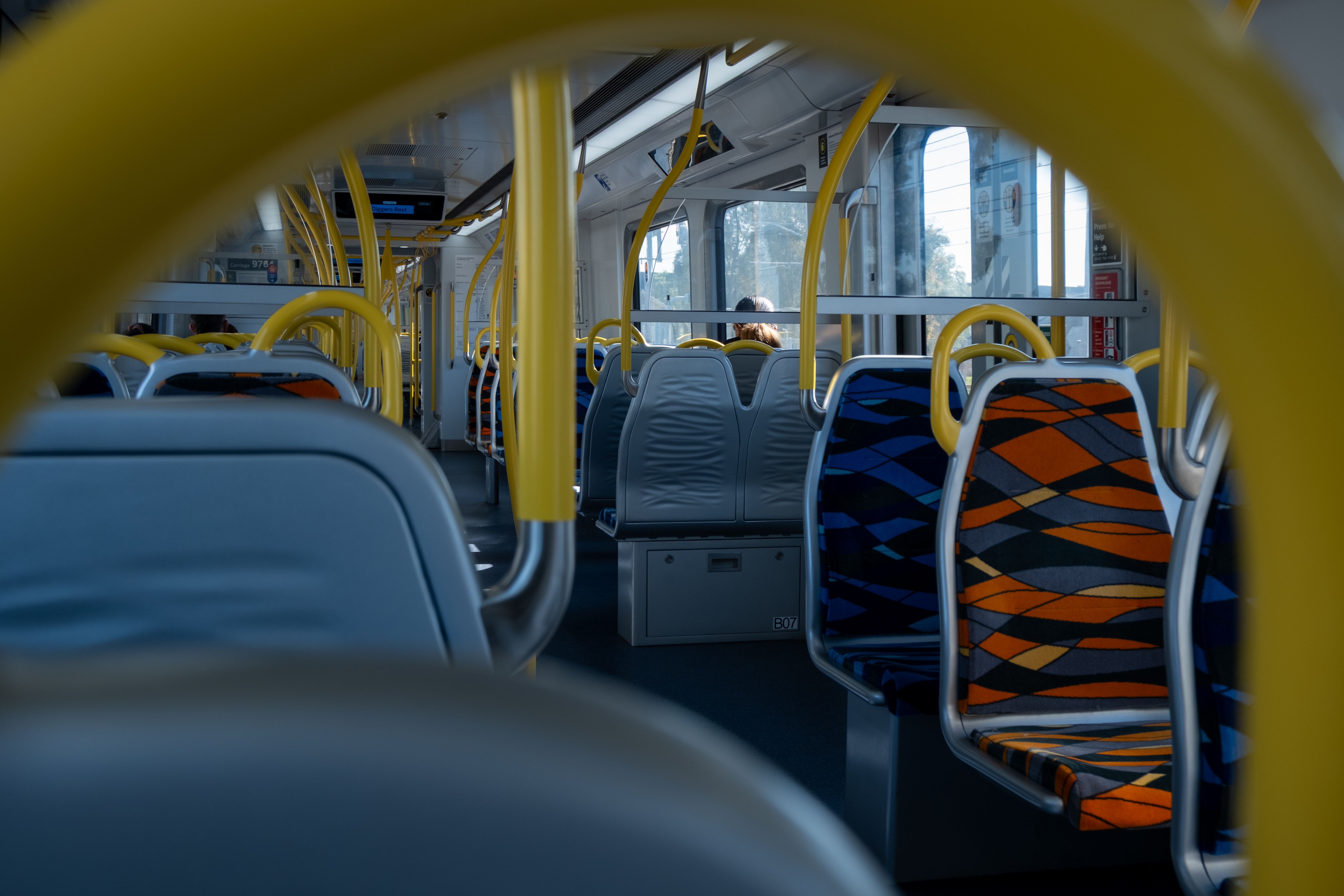 Clean, modern interior of a Madrid Metro train with passengers