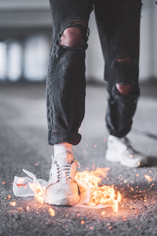 Free Person in Black Denim Jeans and White Sneakers Stock Photo