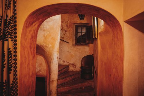 Free Warmly lit rustic staircase with aged walls and vintage decor, creating a cozy atmosphere. Stock Photo