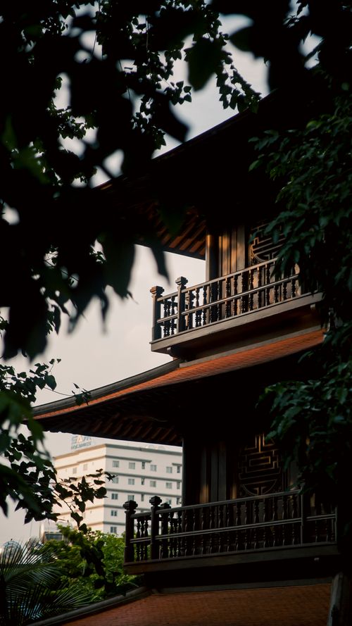 Free A striking view of traditional pagoda architecture framed by trees in Ho Chi Minh City. Stock Photo