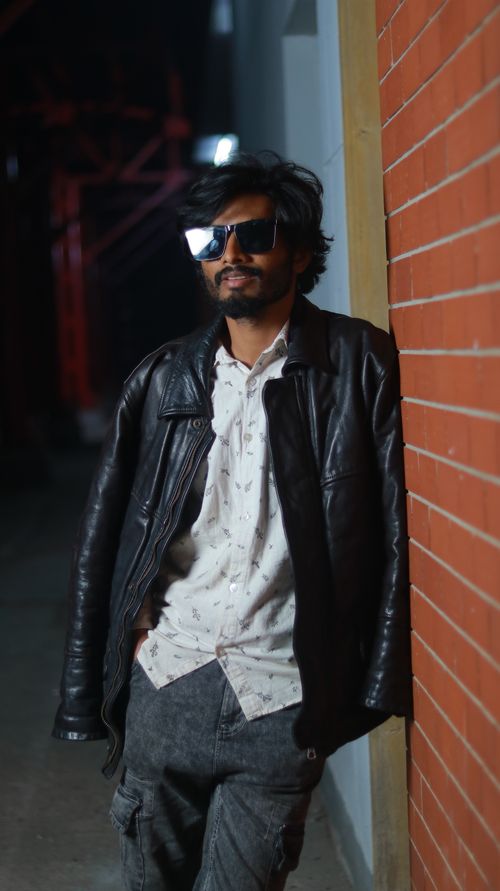 Free Casual portrait of a man in a leather jacket in an urban night setting. Stock Photo