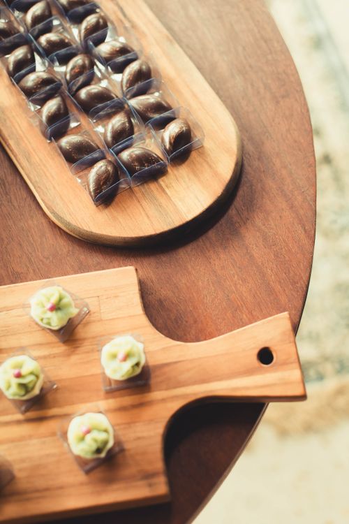 Free High-angle view of a wedding table with gourmet chocolates and sweets on wooden serving boards, creating a sophisticated setting. Stock Photo