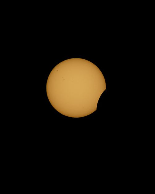 Free Vibrant image capturing a partial solar eclipse against a dark sky in Castellón, España. Stock Photo