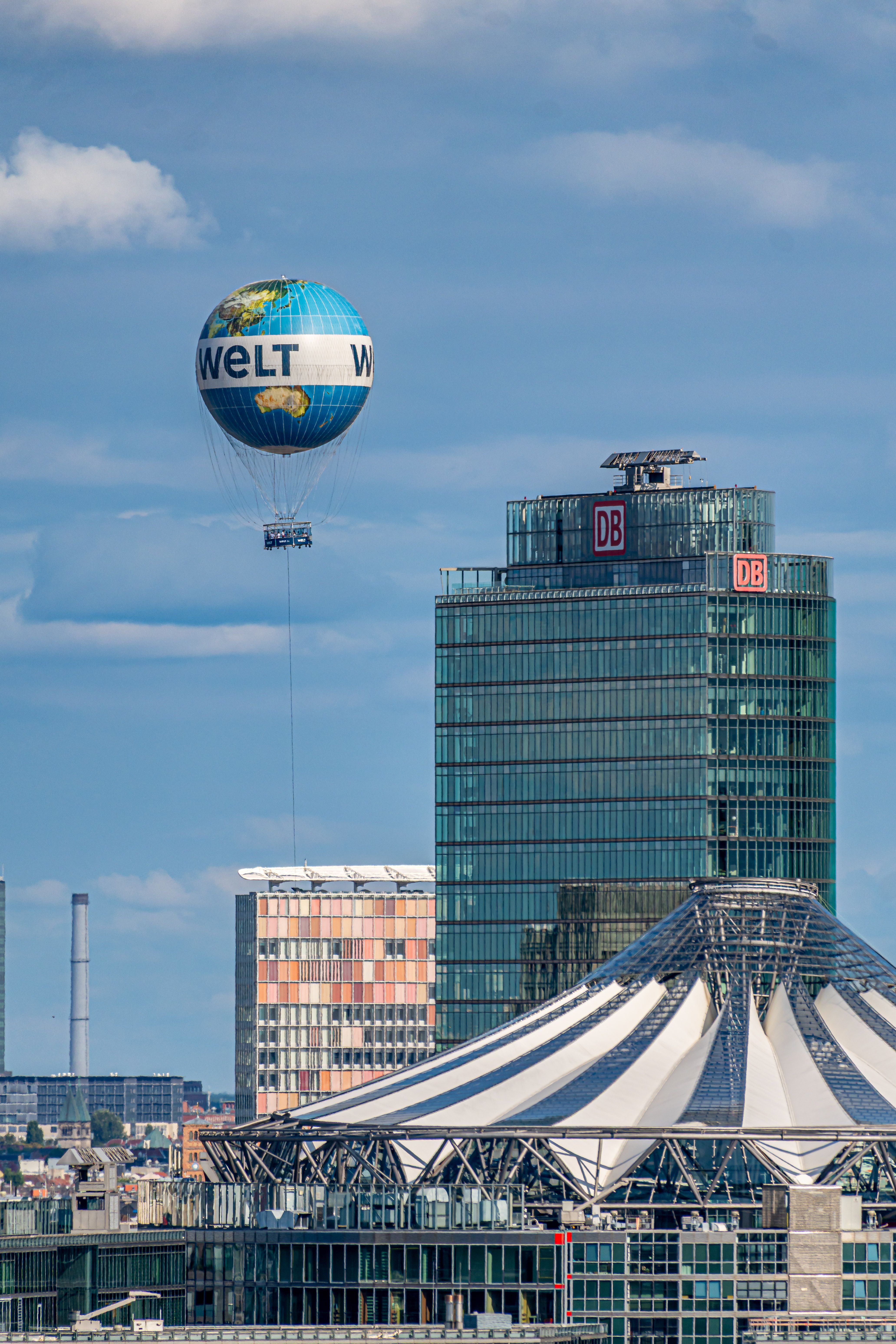 Scenic view of Welt balloon flying over Berlin's Potsdamer Platz with DB Tower in background.
