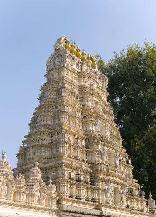Free An ornate Hindu temple tower, showcasing intricate carvings and architecture under a clear sky. Stock Photo