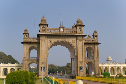 Free Stunning archway entrance of Mysore Palace in Karnataka, showcasing regal architecture under a clear blue sky. Stock Photo