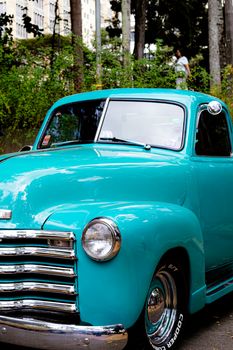 A vibrant vintage blue truck parked outdoors in Belo Horizonte, Brazil.