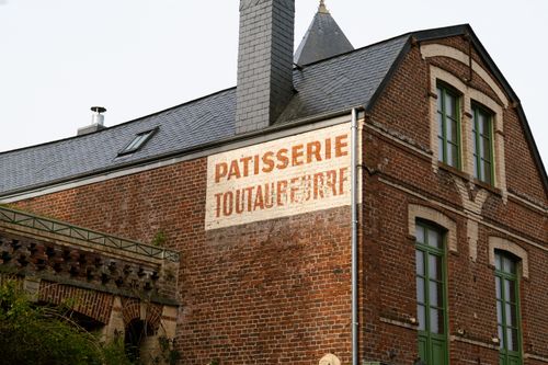 Free Historic brick building with old patisserie sign in Veules-les-Roses, Normandy. Stock Photo