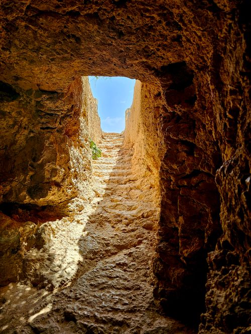 Free Discover an ancient stone stairway illuminated by natural light, leading upwards outdoors. Stock Photo