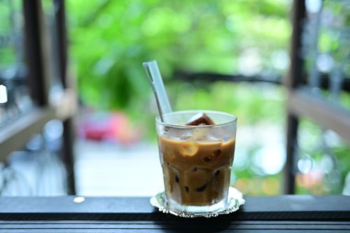 Free A chilled iced coffee in a glass with a straw outdoors, perfect for a summer day. Stock Photo