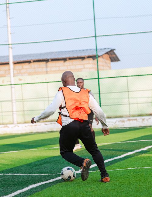 Free Two men playing soccer on a sunny day in an outdoor field, showcasing athleticism. Stock Photo