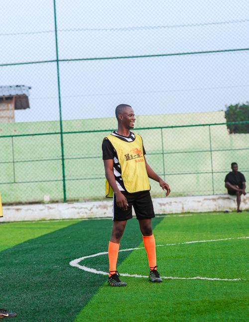 Free A young male soccer player in action on a turf field during the day. Training session. Stock Photo