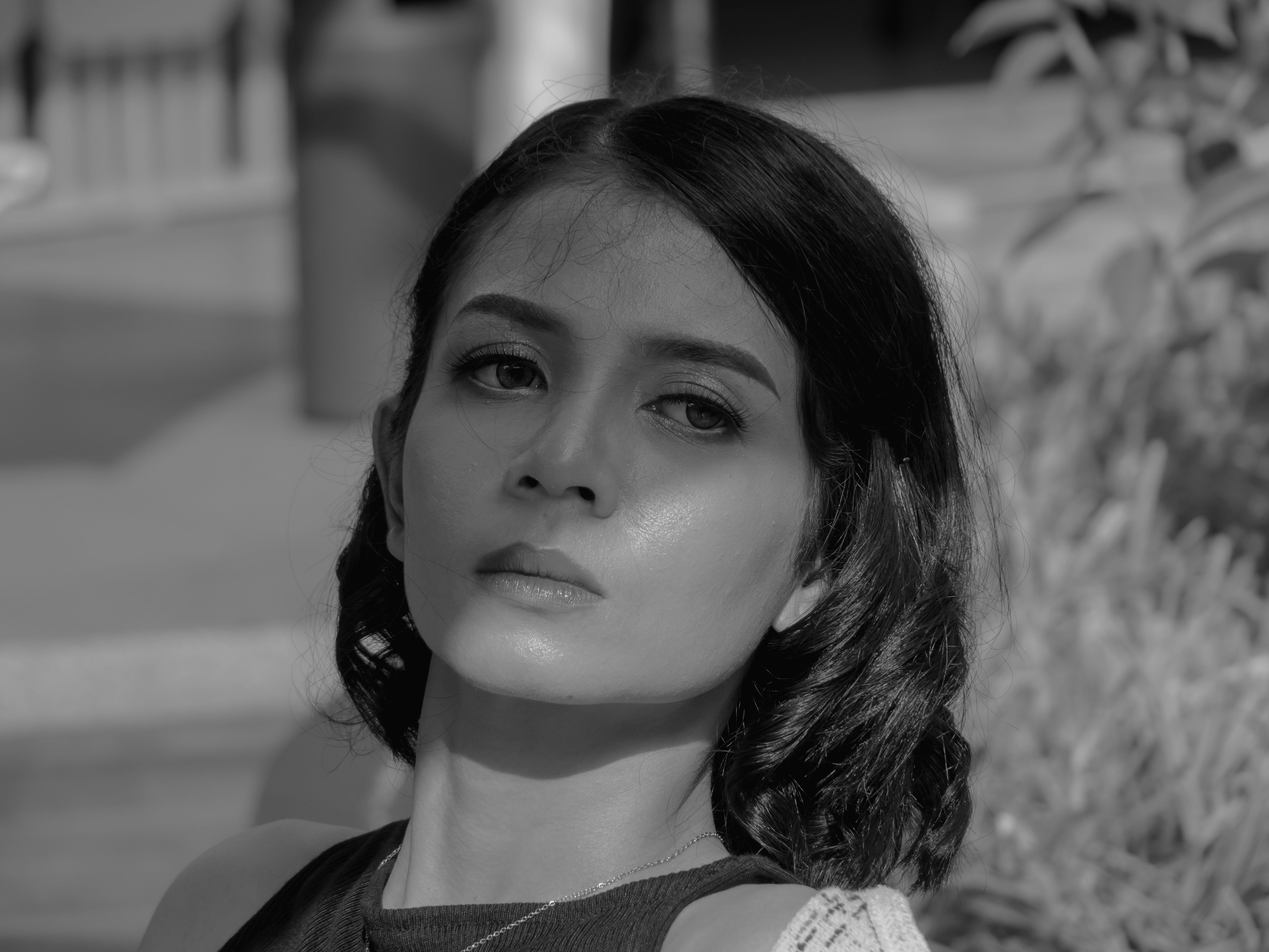 Stylish black and white portrait of a woman in Jakarta, capturing a serene expression.