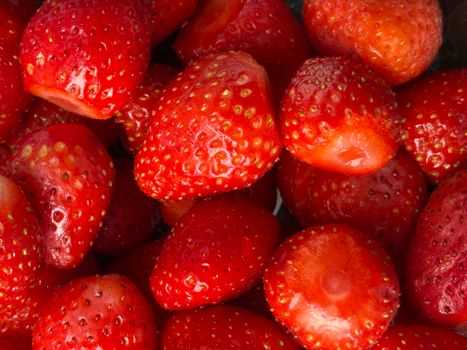 Vibrant close-up of fresh red strawberries, showcasing their juicy texture and bright color.