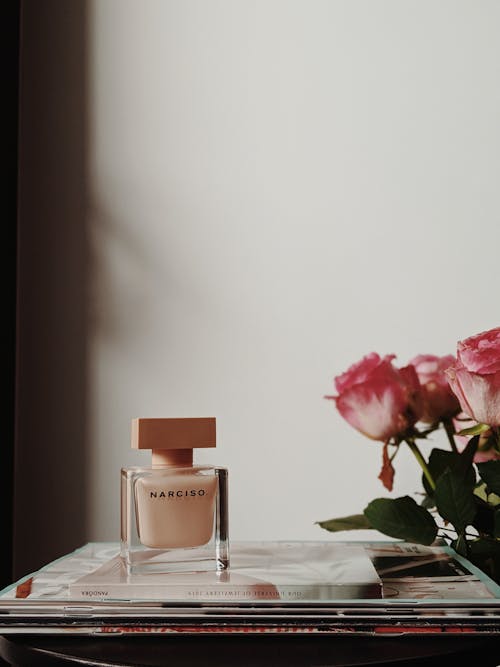 Pink Roses and Perfume Bottle White Table