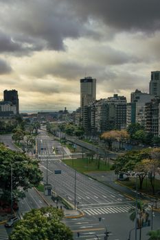Dramatic view of Buenos Aires cityscape with streets and cloudy sky during the day.