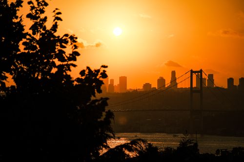 Free Stunning sunset view of the Bosphorus Bridge silhouetted against Istanbul's skyline. Stock Photo