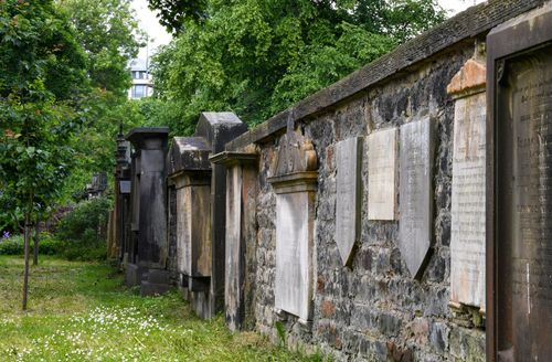Free Explore the historic tombstones of St Cuthbert's Kirkyard in Edinburgh, Scotland, nestled among lush greenery. Stock Photo