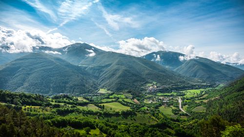 Free Stunning view of lush green mountains under a clear blue sky. Stock Photo